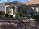 Landscaped backyard with covered patio and AC unit at 10321 Junction Hill Dr, Las Vegas, NV 89134