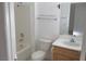 Clean bathroom with bathtub, toilet and wood vanity at 10321 Junction Hill Dr, Las Vegas, NV 89134