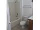 Bathroom with tub, toilet and wood vanity at 10321 Junction Hill Dr, Las Vegas, NV 89134