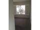 Bedroom with grey carpet and window showing garden view at 10321 Junction Hill Dr, Las Vegas, NV 89134