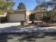 Single-story house with attached garage, landscaping, and desert landscaping at 10321 Junction Hill Dr, Las Vegas, NV 89134