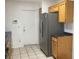 Stainless steel refrigerator, light wood cabinets, and dark countertops at 10321 Junction Hill Dr, Las Vegas, NV 89134