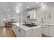 Stylish kitchen boasting white cabinets, marble island, and a farmhouse sink at 10729 Grey Havens Ct, Las Vegas, NV 89135