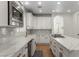 Elegant kitchen featuring white cabinets, a farmhouse sink, and marble countertops at 10729 Grey Havens Ct, Las Vegas, NV 89135