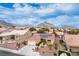 Aerial view of single-story home with solar panels and landscaped yard, mountain views at 11008 Hawk Valley Ave, Las Vegas, NV 89134