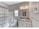 Bright bathroom with a granite countertop vanity, toilet, and shower-tub combination at 1595 Cattle Ranch Pl, Henderson, NV 89002