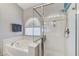 Well-lit bathroom featuring a glass shower, soaking tub, and modern fixtures at 1595 Cattle Ranch Pl, Henderson, NV 89002