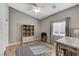 Bedroom with wood floors, a desk, and a large window offering natural light at 1595 Cattle Ranch Pl, Henderson, NV 89002