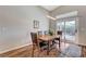 Bright dining area featuring a wood table with seating for four and sliding glass door access to the patio at 1595 Cattle Ranch Pl, Henderson, NV 89002
