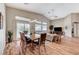 Well-lit dining room offering wood floors, vaulted ceilings, and sliding glass door access to the backyard at 1595 Cattle Ranch Pl, Henderson, NV 89002