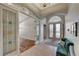 Inviting foyer showcases decorative glass doors and a seating area with views into the living spaces at 1595 Cattle Ranch Pl, Henderson, NV 89002