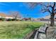 Park green space featuring a concrete bench underneath the shade of a mature tree at 1595 Cattle Ranch Pl, Henderson, NV 89002
