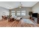 Open-concept living area with high ceilings, wood flooring and seamless access to dining at 1595 Cattle Ranch Pl, Henderson, NV 89002
