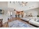 Open-concept living room with a large sectional sofa, wood floors, and views into the kitchen at 1595 Cattle Ranch Pl, Henderson, NV 89002