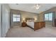Cozy main bedroom with a wood bed frame, lamps, and neutral decor at 1595 Cattle Ranch Pl, Henderson, NV 89002