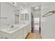 Clean bathroom featuring a double sink vanity, large mirror, and ample lighting at 1900 N Torrey Pines Dr # 112, Las Vegas, NV 89108
