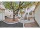 Exterior view of a multi-story home with stone walkway and exterior stairs to upper units at 1900 N Torrey Pines Dr # 112, Las Vegas, NV 89108