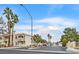 Low angle exterior shot of a multistory condo complex with a gated entrance and mature palm trees at 1900 N Torrey Pines Dr # 112, Las Vegas, NV 89108
