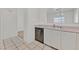 Bright kitchen featuring white cabinets, stainless steel dishwasher, and tile floors at 1900 N Torrey Pines Dr # 112, Las Vegas, NV 89108