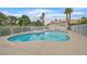 An in ground residential pool and hot tub with white fencing, palm trees, and changing rooms at 1900 N Torrey Pines Dr # 112, Las Vegas, NV 89108