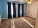 Bright bedroom with two windows and neutral carpeting at 2060 Mesquite Ln # 104, Laughlin, NV 89029