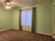 Light green bedroom with large window and ceiling fan at 2060 Mesquite Ln # 104, Laughlin, NV 89029