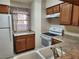 Condo kitchen with white appliances and wood cabinets at 2060 Mesquite Ln # 104, Laughlin, NV 89029