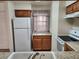 Condo kitchen with white appliances and wood cabinets at 2060 Mesquite Ln # 104, Laughlin, NV 89029