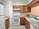 Condo kitchen with white appliances and wood cabinets at 2060 Mesquite Ln # 104, Laughlin, NV 89029