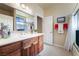 Bathroom with wood vanity, tiled floor and shower/tub combo at 2061 Iroquois Ave, Pahrump, NV 89048