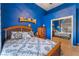 Blue bedroom with wood bed frame and mirrored closet doors at 2061 Iroquois Ave, Pahrump, NV 89048