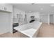 Modern kitchen with white cabinetry, quartz countertops, and stainless steel appliances at 2116 Fuller Rd, Las Vegas, NV 89108