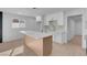 Modern kitchen with white cabinets, center island, and light wood flooring at 2116 Fuller Rd, Las Vegas, NV 89108