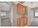 View of a hallway with wood cabinets and access to bedrooms at 2144 Buckeye Reef St, Henderson, NV 89002