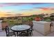 Private balcony with seating area and stunning sunset view at 22 Rue Grimaldi Way, Henderson, NV 89011