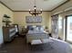 Comfortable bedroom with a queen-size bed and access to a balcony at 22 Rue Grimaldi Way, Henderson, NV 89011