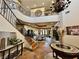 Two-story entryway showcasing a staircase, chandelier, and views to the dining room at 22 Rue Grimaldi Way, Henderson, NV 89011