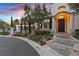 Beautiful home exterior with stone steps, manicured landscaping, and an arched entryway at 22 Rue Grimaldi Way, Henderson, NV 89011