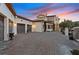 Exterior of home with a multi-car garage, driveway, and desert landscaping at 22 Rue Grimaldi Way, Henderson, NV 89011