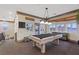 Spacious game room with pool table, views from many windows, and neutral color palette at 22 Rue Grimaldi Way, Henderson, NV 89011