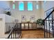 Upper hallway with hardwood floors, a built-in cabinet, and a view of the staircase at 22 Rue Grimaldi Way, Henderson, NV 89011