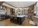 A spacious kitchen with custom cabinetry, a large island with seating, and modern stainless steel appliances at 22 Rue Grimaldi Way, Henderson, NV 89011