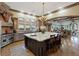 A gourmet kitchen with a large island, modern appliances, hardwood floors, and views to the living room at 22 Rue Grimaldi Way, Henderson, NV 89011