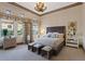 Bright main bedroom features large windows, decorative curtains, and carpeted floors at 22 Rue Grimaldi Way, Henderson, NV 89011