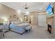 Luxurious main bedroom with fireplace, large windows, and a sitting area at 22 Rue Grimaldi Way, Henderson, NV 89011