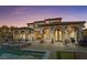 Backyard oasis featuring a sparkling pool, spa, covered patio, and lush desert landscaping at 22 Rue Grimaldi Way, Henderson, NV 89011