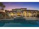 A luxurious home with a pool, spa, outdoor fireplace, arched columns, and a scenic view at 22 Rue Grimaldi Way, Henderson, NV 89011