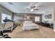 Main bedroom with large bed, home gym area, and wood-like wall accents at 3307 Cypress Springs Ct, Las Vegas, NV 89141