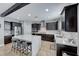 Modern kitchen with dark wood cabinets, white herringbone backsplash, and large island at 3307 Cypress Springs Ct, Las Vegas, NV 89141