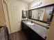 Bathroom with dark vanity, large mirror, and shower at 3550 Bay Sands Dr # 1017, Laughlin, NV 89029